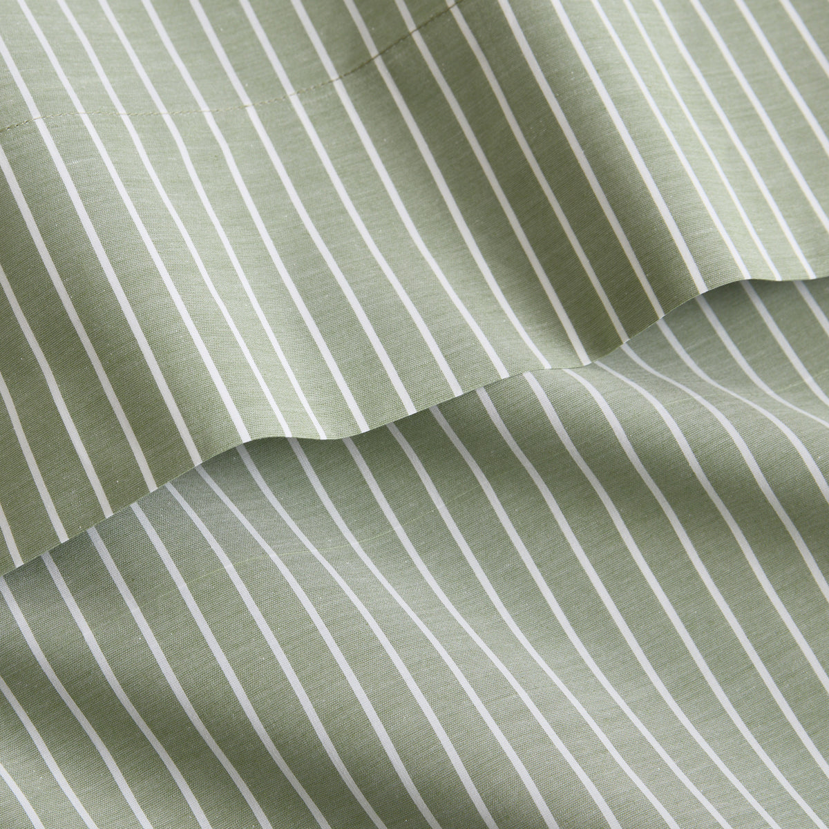 Green and white striped cotton percale sheet set with a crisp, yarn-dyed finish and sewed trim detail.