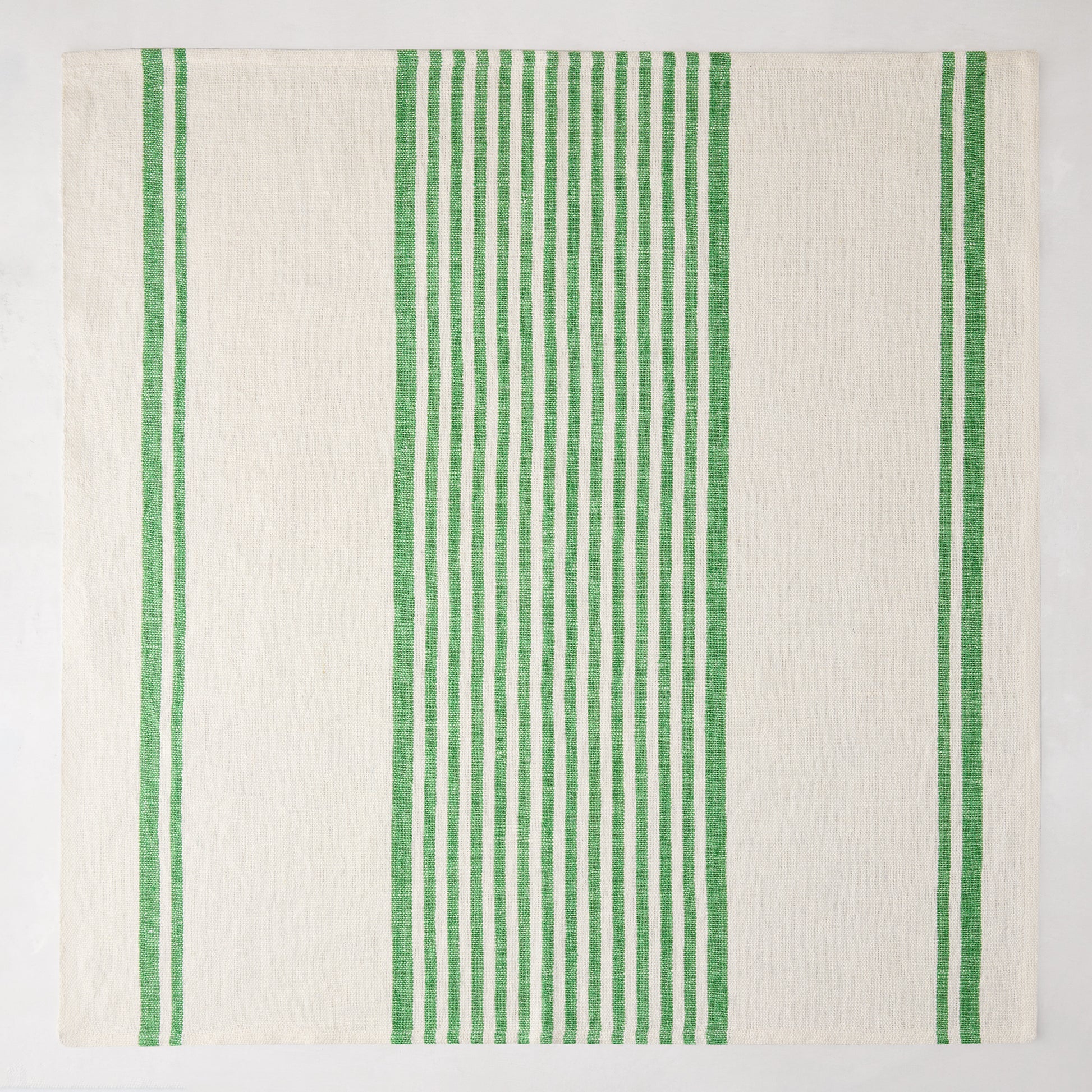 Green Boat Stripe Napkin, 22" square, washed cotton-linen blend, with vertical green stripes on cream.