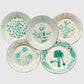 Hudson Grace Casa Nuno ceramic dinner plates featuring hand-painted green botanical designs on cream backgrounds.
