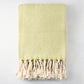 Green chevron cotton throw blanket with thick rope fringe.