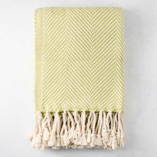 Green chevron cotton throw blanket with thick rope fringe.