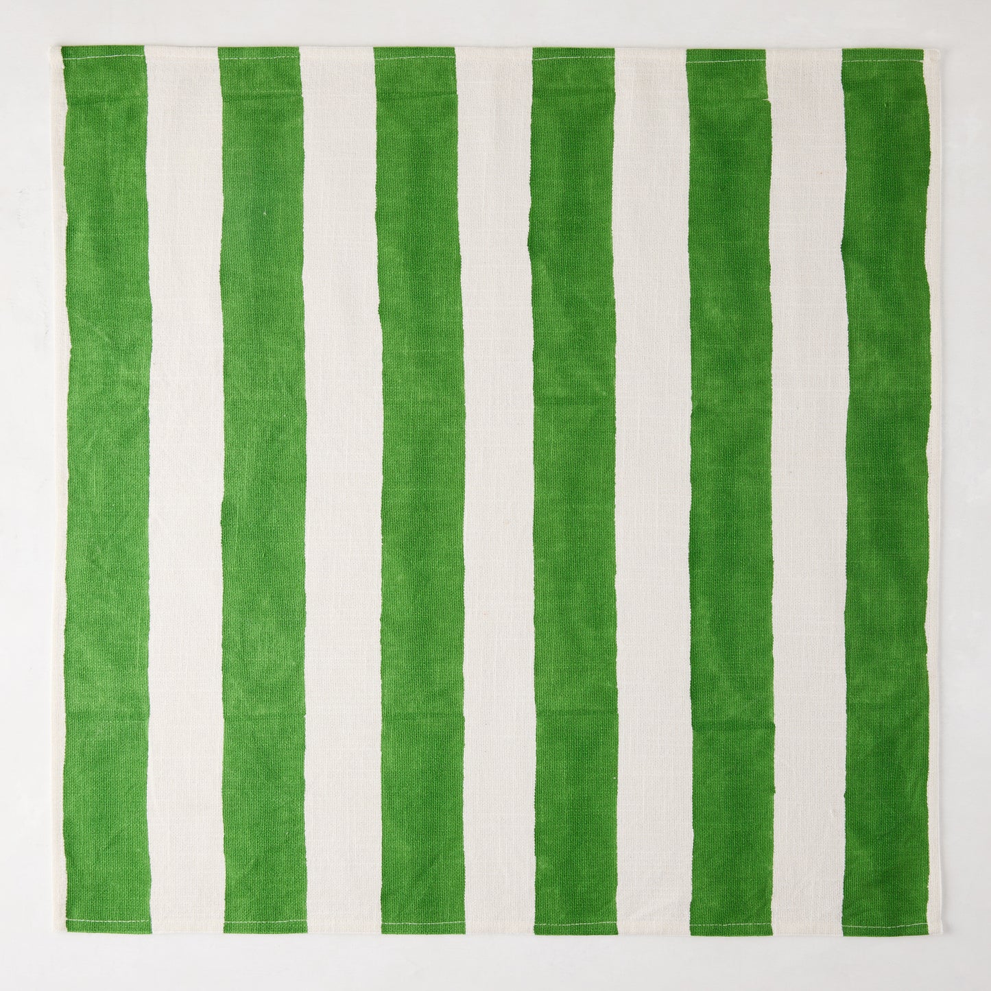 Green Hampton Cotton Stripe Napkin, 22" square, with bold green and white vertical stripes.