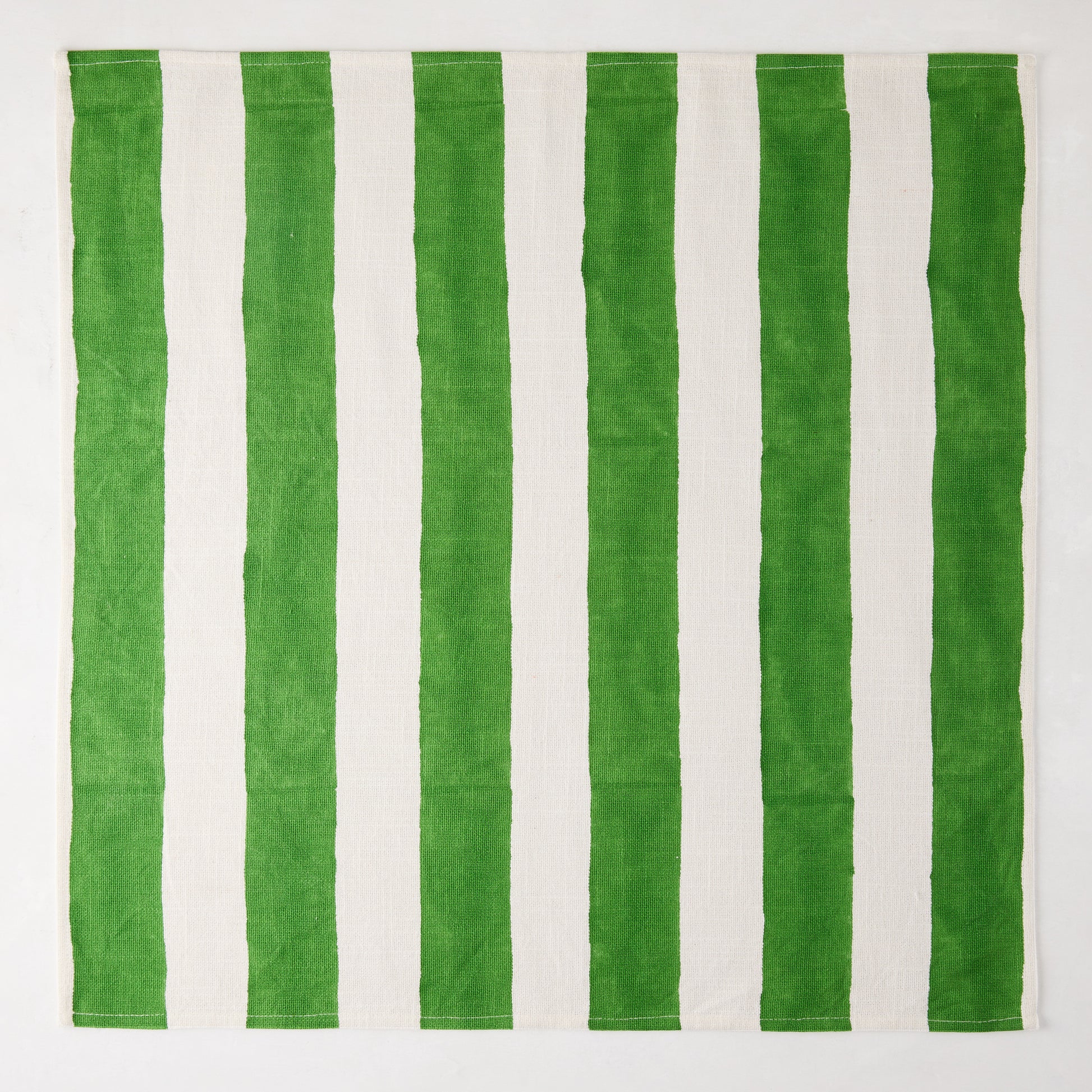 Green Hampton Cotton Stripe Napkin, 22" square, with bold green and white vertical stripes.