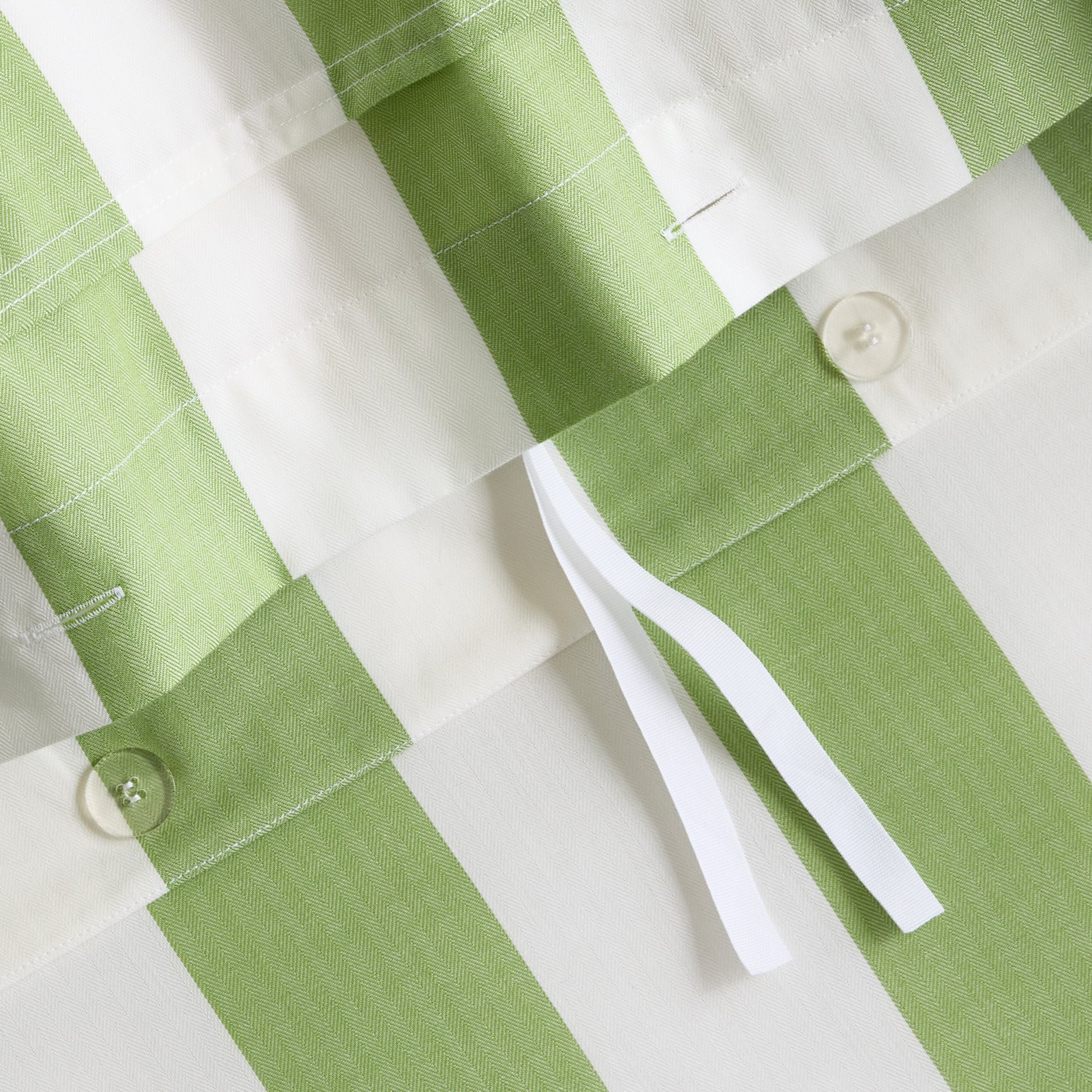 Green and white herringbone striped cotton duvet cover with button and tie closures.