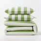 Green and white wide-striped duvet cover and two matching pillow shams stacked on a white background.