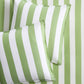 Set of two green and white wide-striped herringbone Euro shams on matching striped bedding.