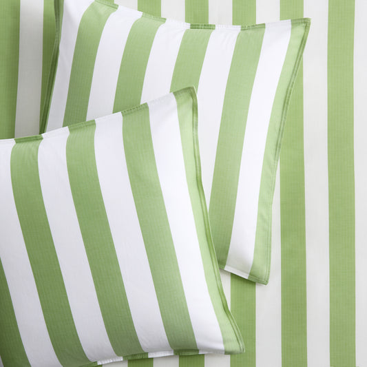 Set of two green and white wide-striped herringbone Euro shams on matching striped bedding.