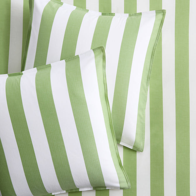 Set of two green and white wide-striped herringbone Euro shams on matching striped bedding.