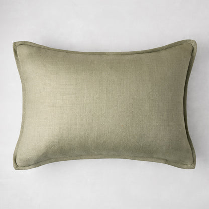 Celadon green linen lumbar pillow, 20"L x 14"H, with subtle texture and piped edges.