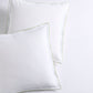 Set of two white percale Euro shams with delicate green piping and double-stitch detailing.