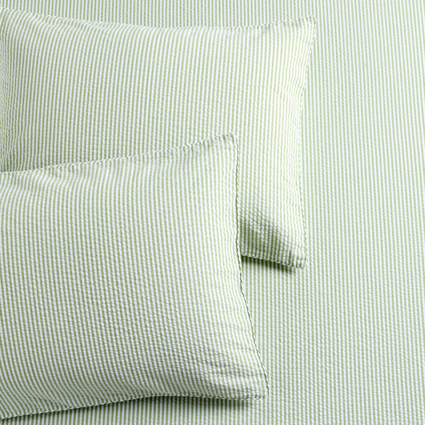 Green seersucker stripe organic cotton duvet cover and two shams with a textured finish.