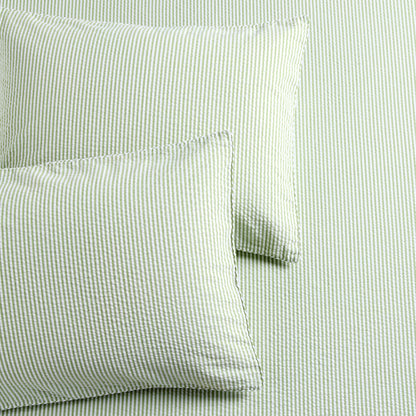 Green seersucker stripe organic cotton duvet cover and two shams with a textured finish.