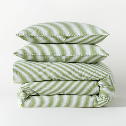 Stacked green seersucker stripe organic cotton duvet and two shams.