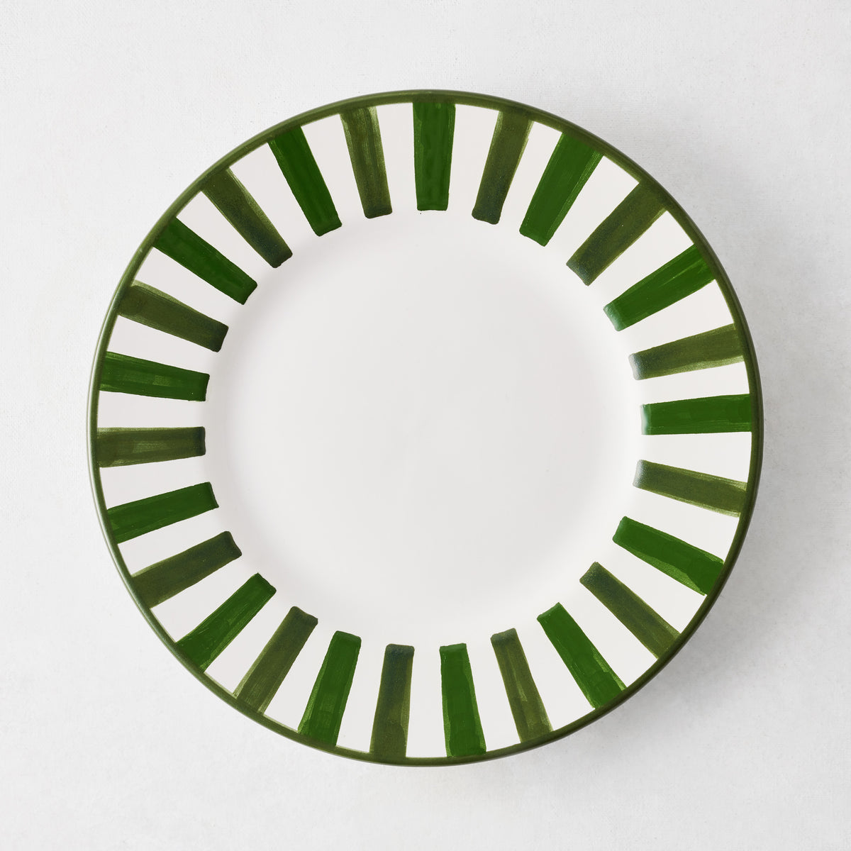 Round white ceramic salad plate featuring a hand-painted green striped border on a plain white background.