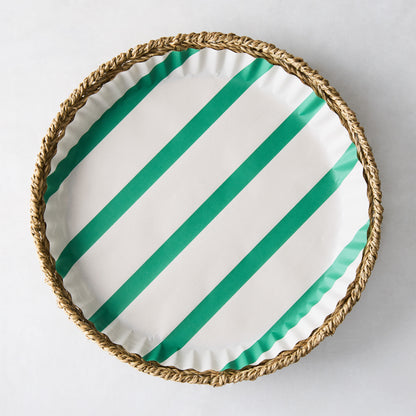 Round white parchment liner with green diagonal stripes in a woven basket.