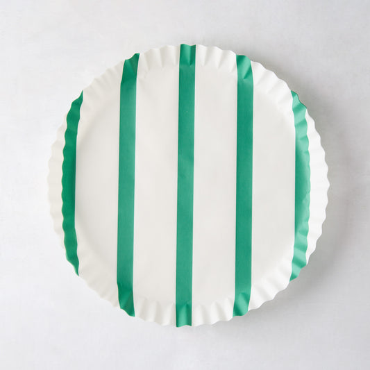 White round parchment liner with green vertical stripes and ruffled edges.