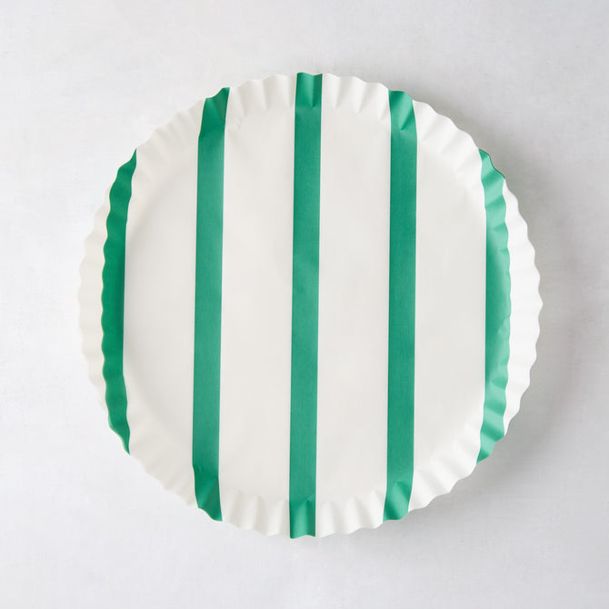 White round parchment liner with green vertical stripes and ruffled edges.