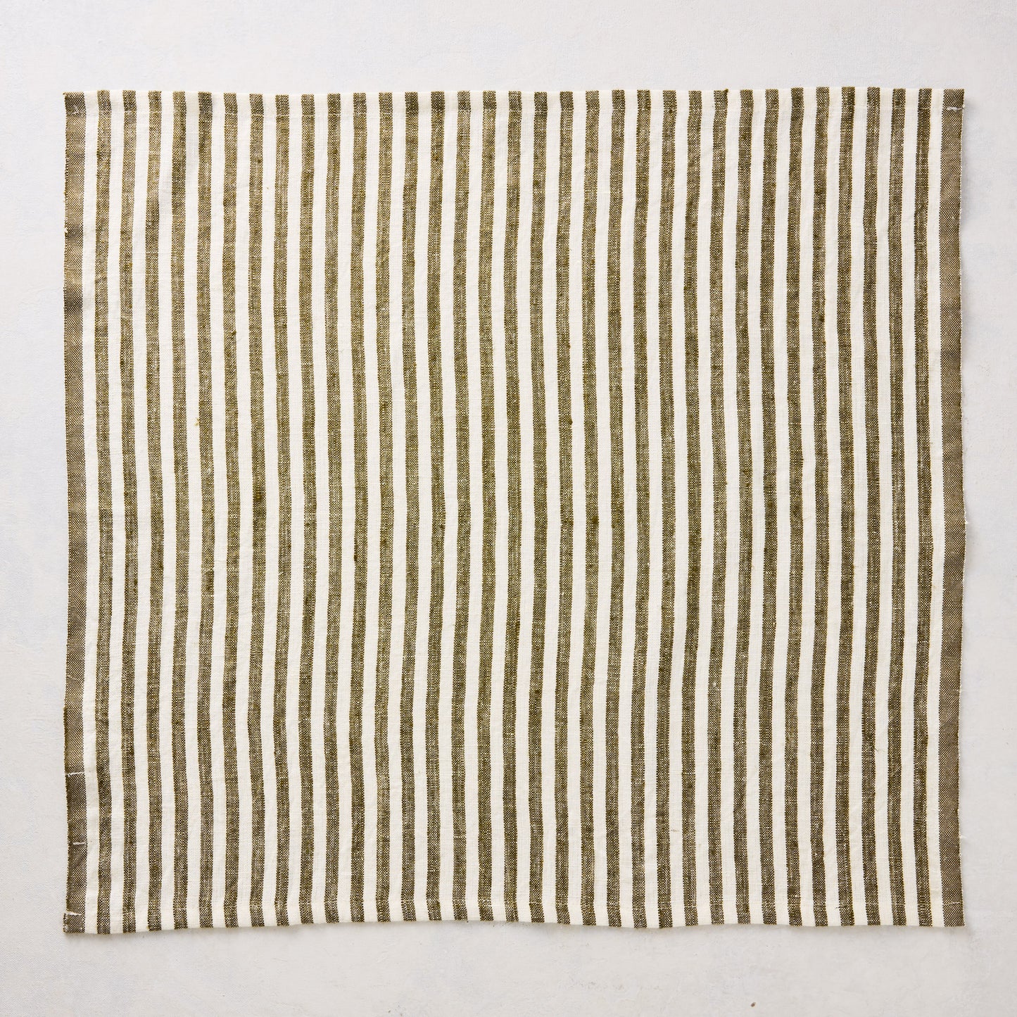 21-inch square linen napkin with green and white ticking stripes on a white background.