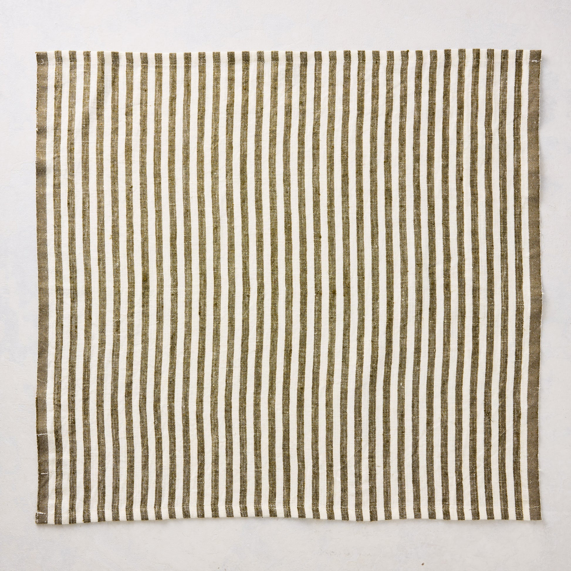 21-inch square linen napkin with green and white ticking stripes on a white background.