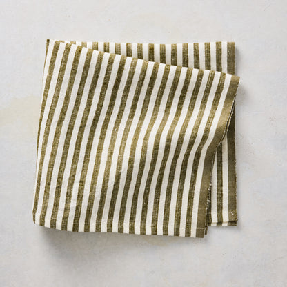 Folded 21-inch square linen napkin with green and white ticking stripes on a neutral background.