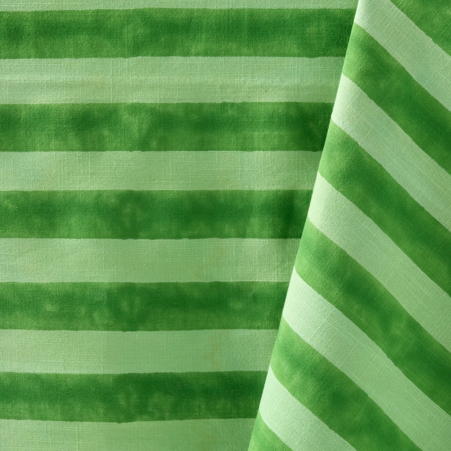 Green Tonal Hampton Stripe Cotton Tablecloth, 70"W x 108"L, with bold horizontal and diagonal stripes.