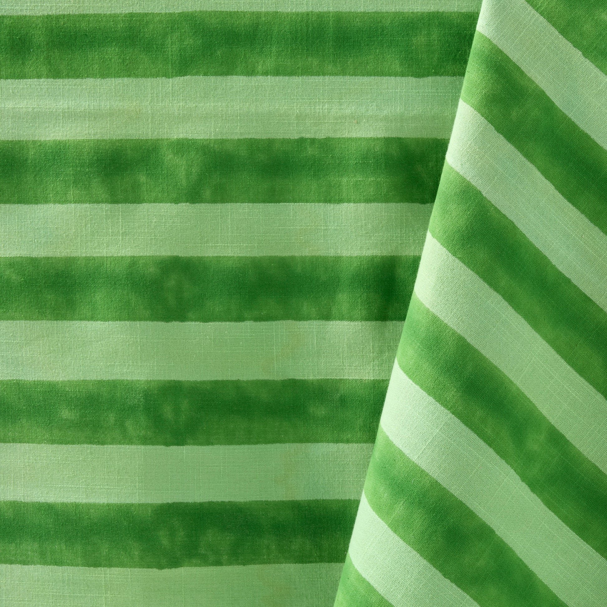 Green Tonal Hampton Stripe Cotton Tablecloth, 70"W x 108"L, with bold horizontal and diagonal stripes.