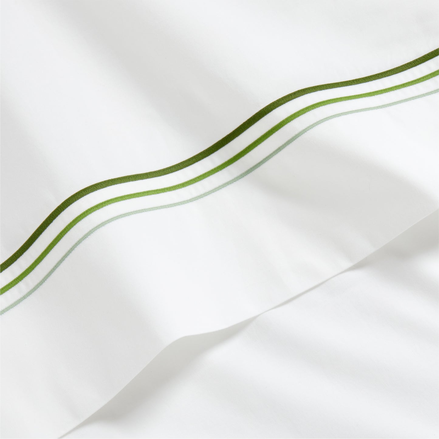 White percale sheet with a green triple-stitch border.