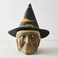 Distressed green papier-mâché witch candy bucket with a black pointed hat, 13 inches tall, vintage Halloween style.