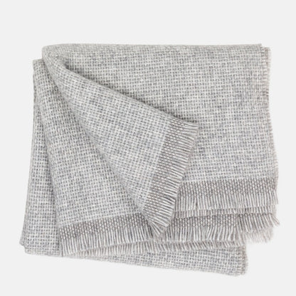 Folded Grey Azolla Alpaca Wool Throw Blanket with fringed edges and a subtle woven texture.