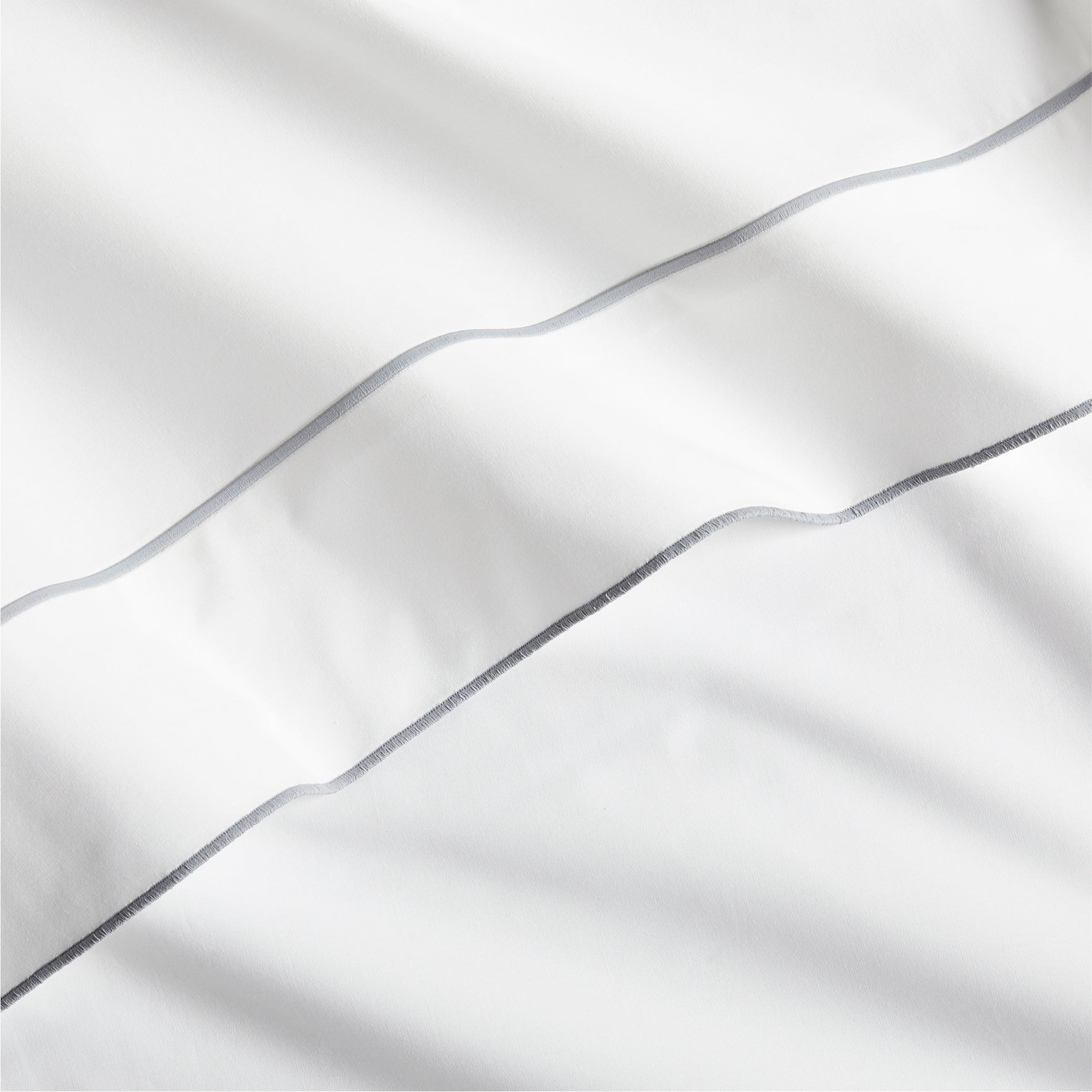 White percale sheet with a grey satin stitch border.