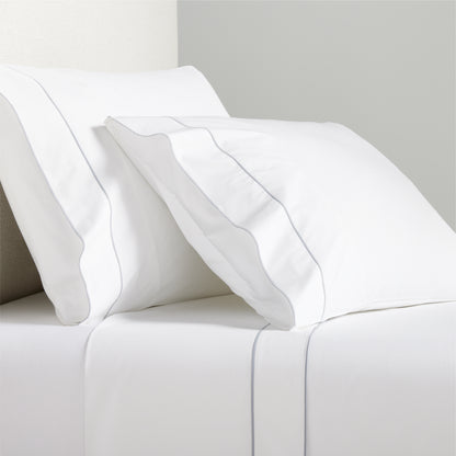 White percale sheet set with grey satin stitch border on pillows and flat sheet.