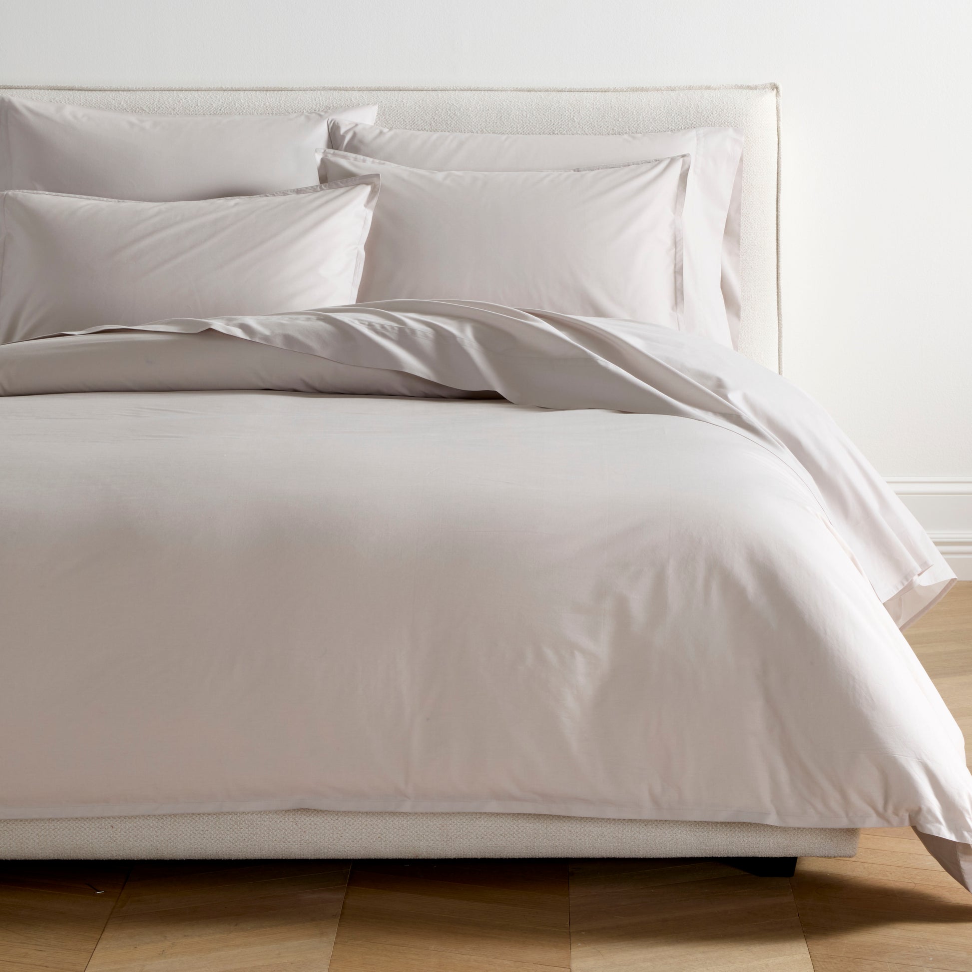 Grey Italian Percale Duvet Set with duvet cover and shams on a bed.