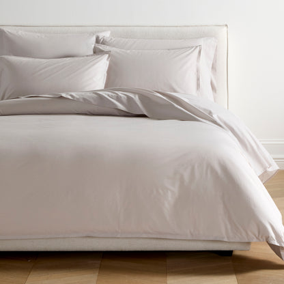 Grey Italian Percale Duvet Set with duvet cover and shams on a bed.