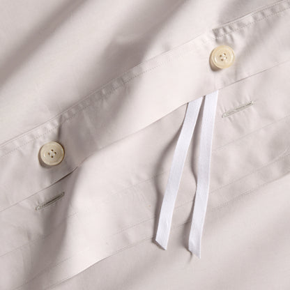Grey Italian percale duvet cover with button closures and white fabric ties.