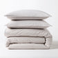Stacked grey Italian percale duvet cover and two shams, made from long-staple cotton.