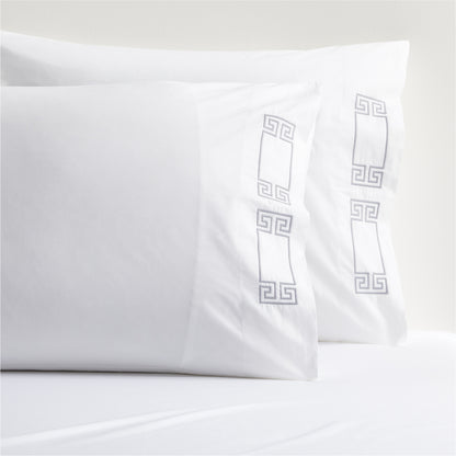White percale pillowcases with grey embroidered Greek key border.