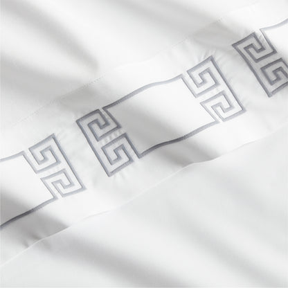 White percale sheet with a grey embroidered Greek key motif band.