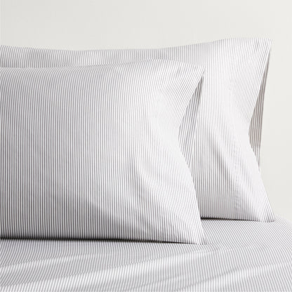 Grey Stripe Cotton-Chambray Sheet Set with two pillowcases, featuring thin vertical stripes.