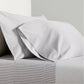 Grey Stripe Cotton-Chambray Sheet Set with thin woven stripes and two pillowcases.