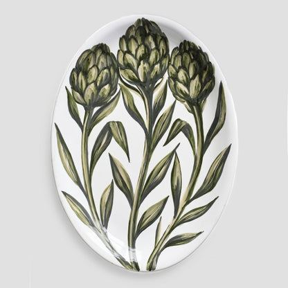 Oval ceramic serve platter with hand-painted green artichoke design on a white glazed background, 15.75 by 11.8 inches.
