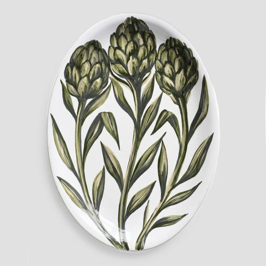 Oval ceramic serve platter with hand-painted green artichoke design on a white glazed background, 15.75 by 11.8 inches.