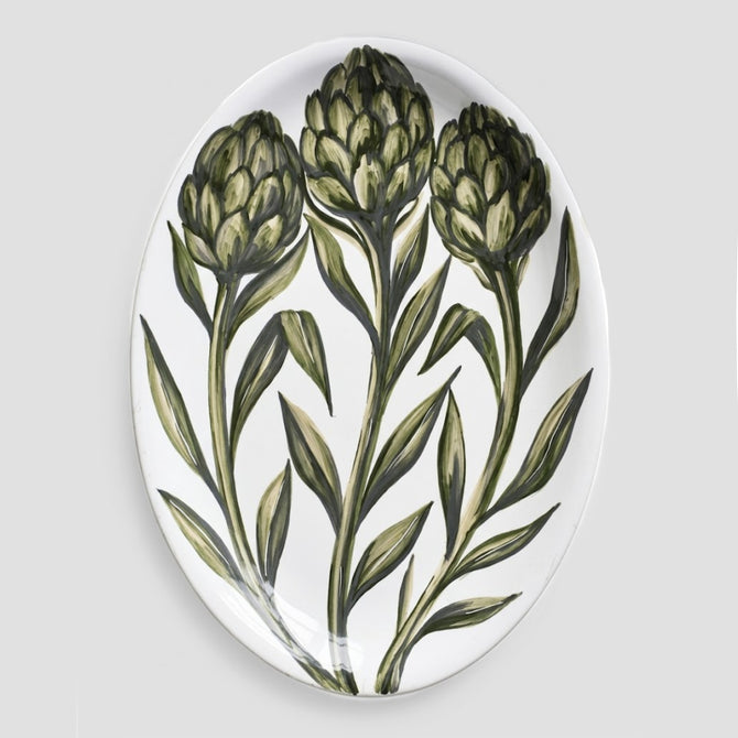 Oval ceramic serve platter with hand-painted green artichoke design on a white glazed background, 15.75 by 11.8 inches.
