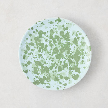 Hand-painted Italian stoneware appetizer plate, 6.3"Dia, with pale blue glaze and green splatter pattern.