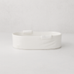 Handmade Montes Doggett small ceramic baker 4696, creamy white, organic shape, with two small handles.