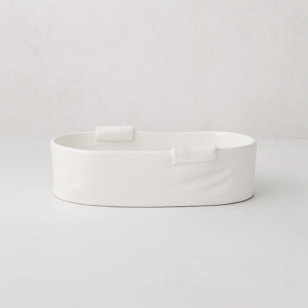 Handmade Montes Doggett small ceramic baker 4696, creamy white, organic shape, with two small handles.
