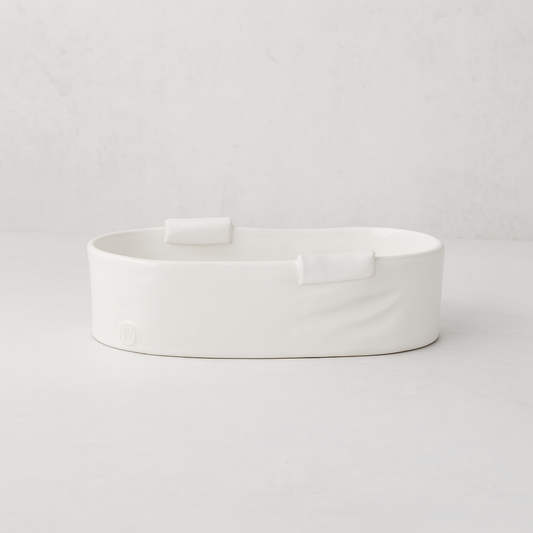 Handmade Montes Doggett small ceramic baker 4696, creamy white, organic shape, with two small handles.