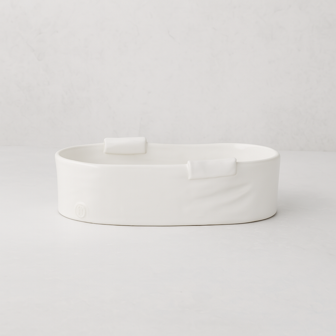 Handmade Montes Doggett small ceramic baker 4696, creamy white, organic shape, with two small handles.