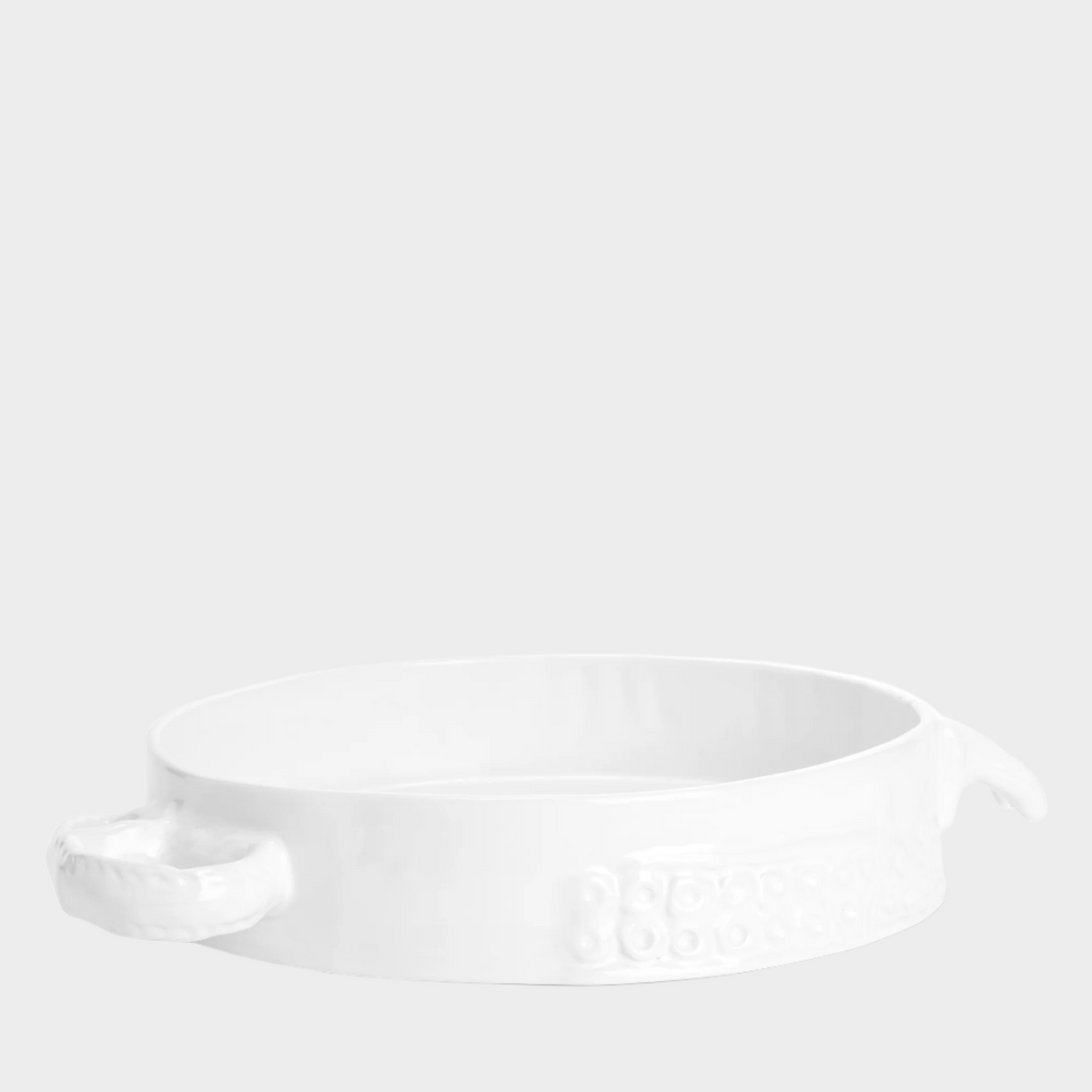 Handmade creamy white ceramic baker by Montes Doggett, 11"Dia, with organic shape and textured handles.