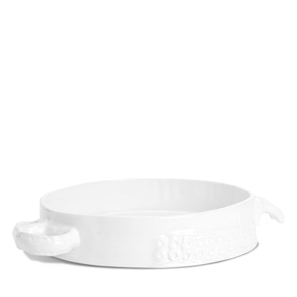 Handmade creamy white ceramic baker by Montes Doggett, 11"Dia, with organic shape and textured handles.