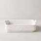 Handmade creamy white ceramic baker by Montes Doggett, organic shape with handles.